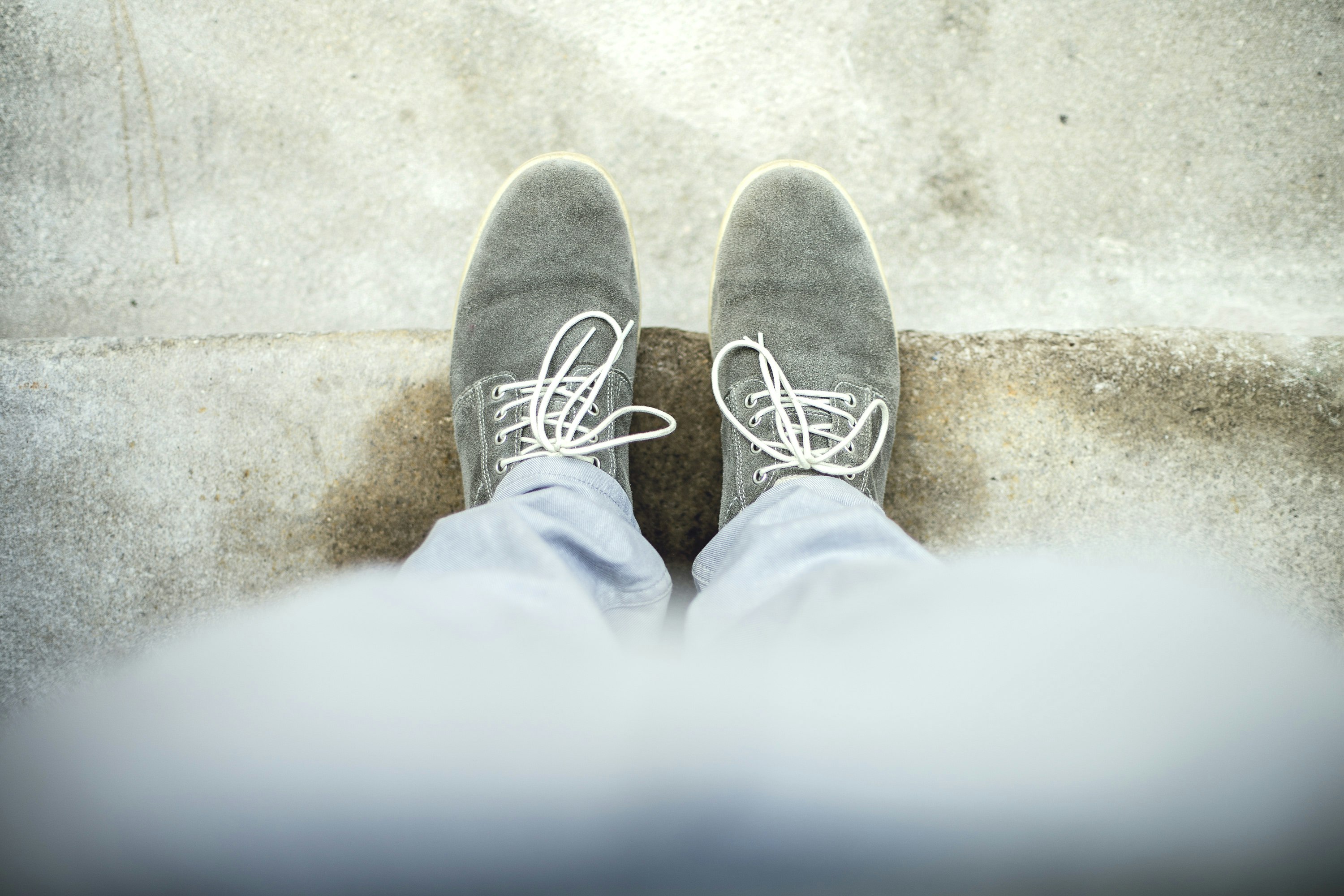 person taking a picture of gray shoes